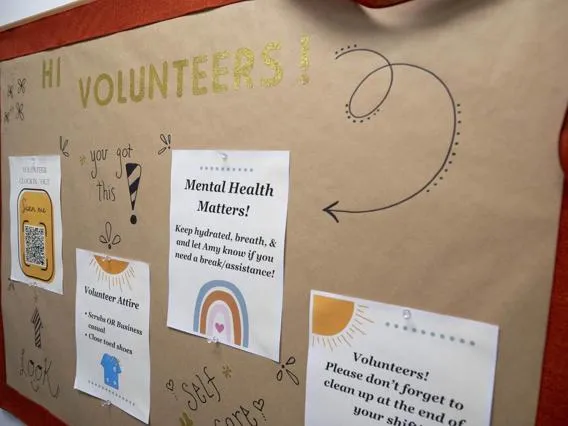 Volunteer greeting board at Casa Alitas Welcome Center