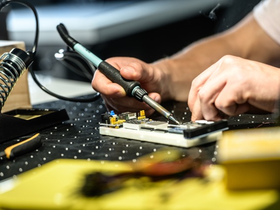 a man soldering a device