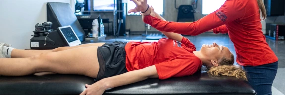 Female physical therapist works with female patient.