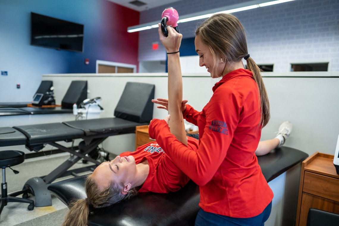Female physical therapist works with female patient.