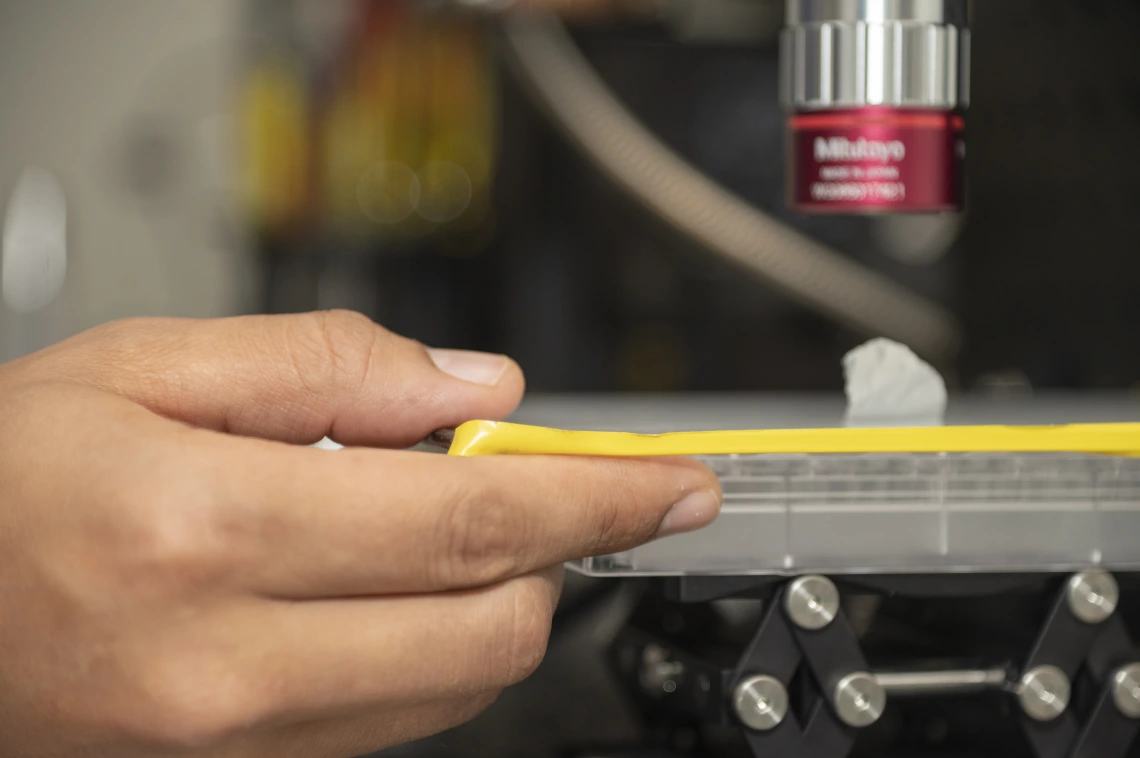 hand holding the side of a piece of equipment