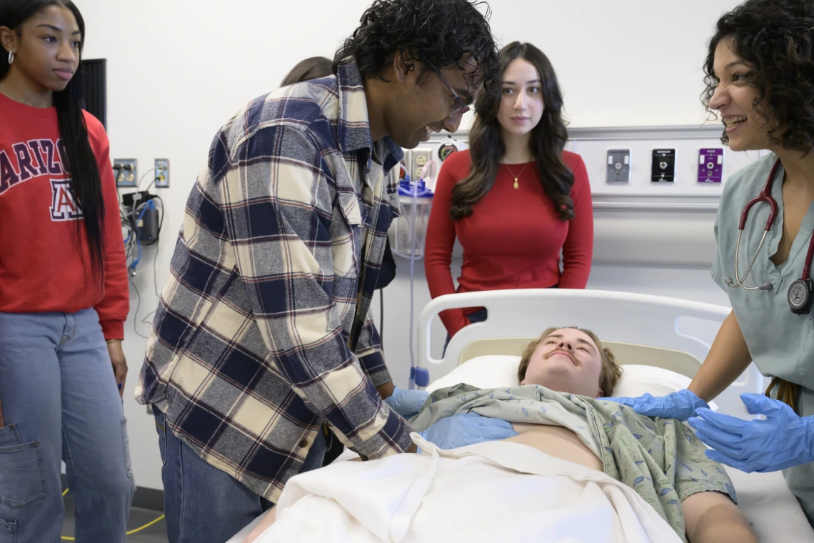 Physician assistant students in an simulation class with a patient