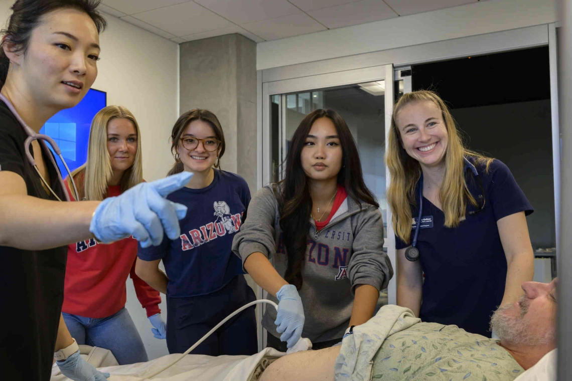 Physician assistant students in an simulation class with a patient