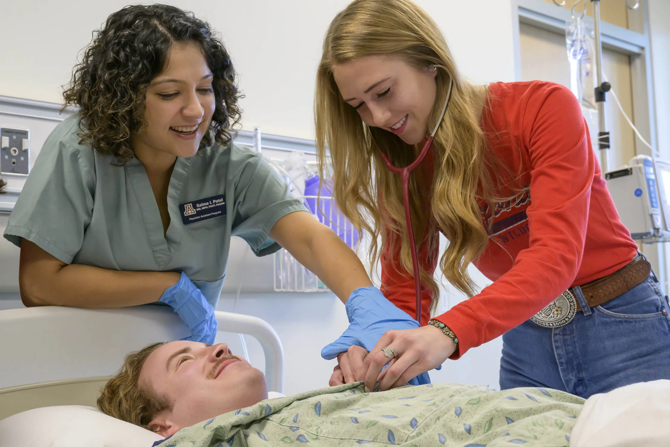 Students practicing an abdomen exam