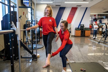 Female physical therapist works with female patient.