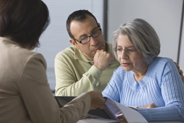 provider showing brochure to patient and family